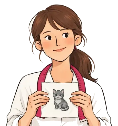 Colette tenant un carré de toile blanche brodé d'un chaton gris au point de croix
